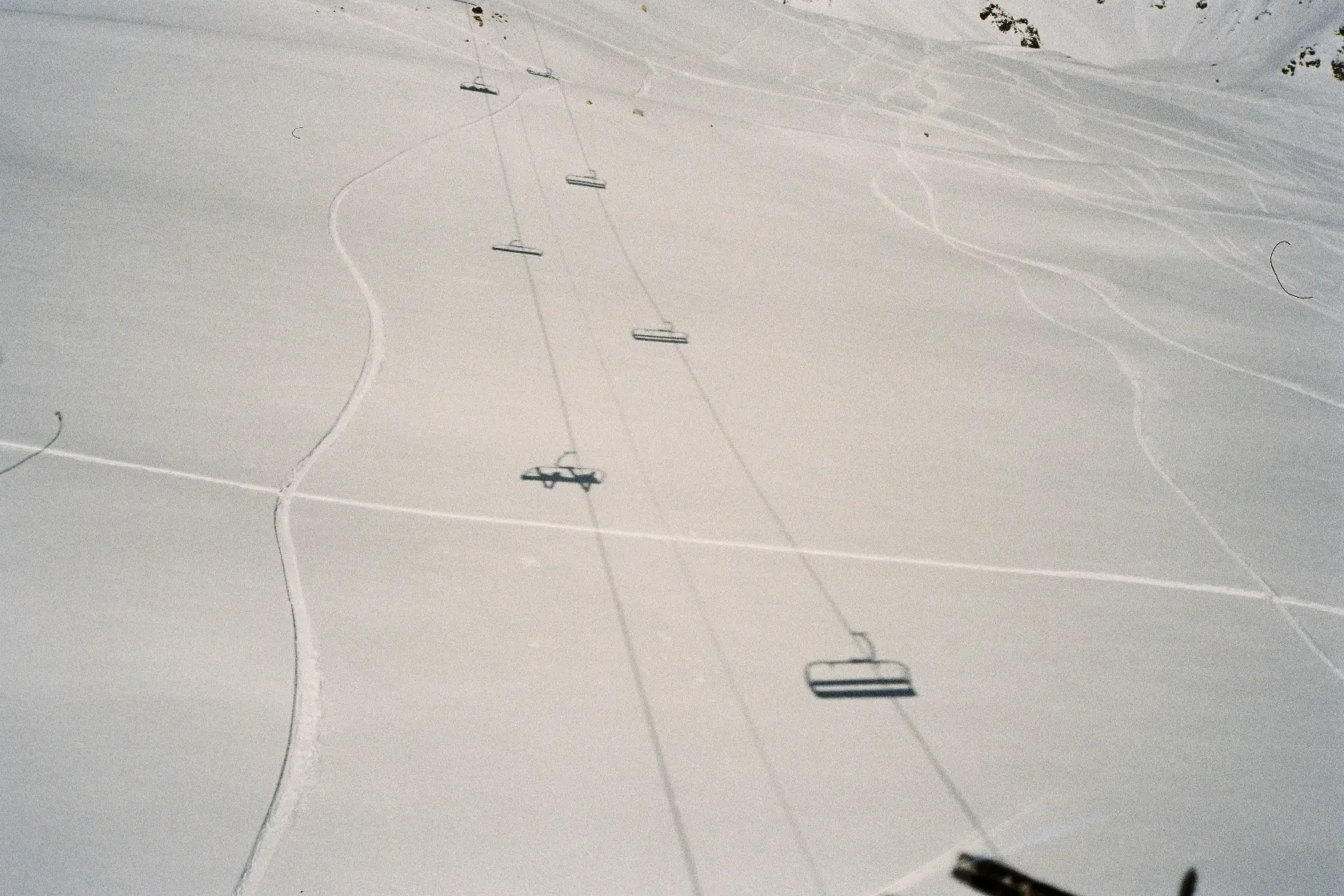 Image of the shadows of Cable Cars on the snowy skiing trail